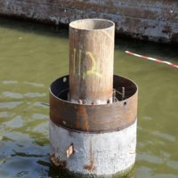 STÅLRØRSPÆL: Her stikker stålrørspælen opp av omstøpningsrøret. Mellomrommet mellom rørene har blitt armert og støpt ut. Litt av armeringsjernet kan skimtes nedi omstøpningsrøret. (Foto: Runar F. Daler).