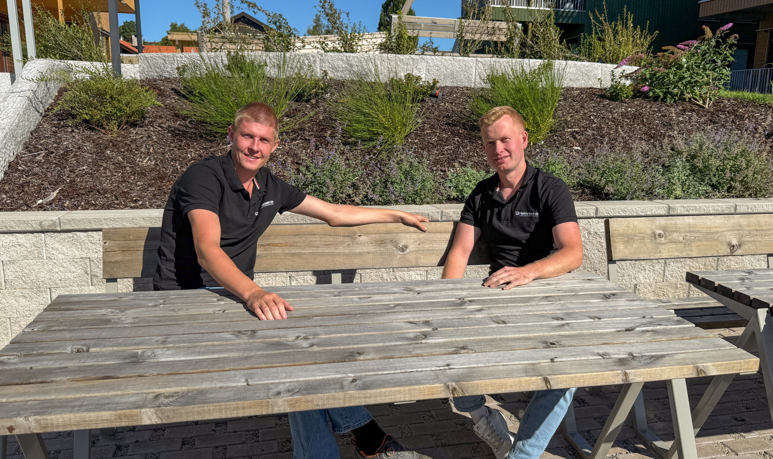 Nikolai Helminsen (t.h.) startet med å klippe gress på naboeiendommer da han var 10 år. I dag leder han et landskapsentreprenørfirma med tolv ansatte. Kollega Elias Lindberg var blant de første som ble ansatt, og har vært med siden 2020. (Foto: Njål Hagen)