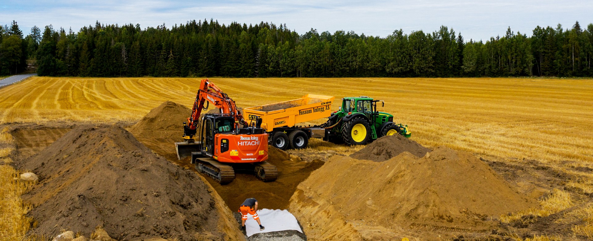 TOSPANN: En ansatt med gravemaskin og en med traktor og henger jobber ofte tett sammen i anleggsområdet. (Foto: Privat)